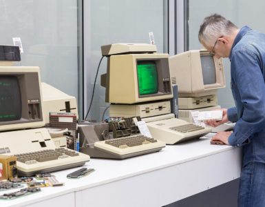 man fixing old computer