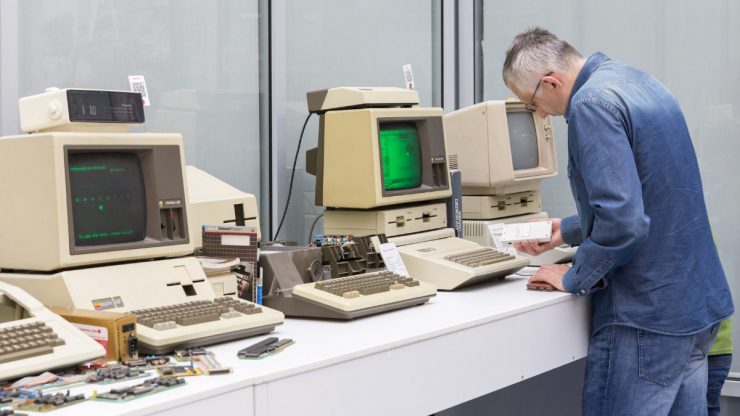 man fixing old computer