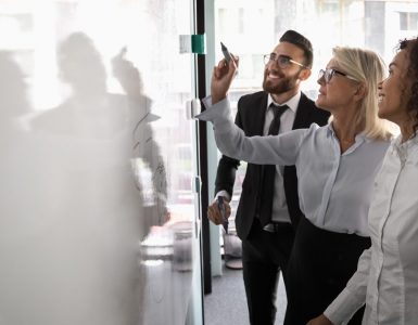 People drawing a map of ATS integrations on a whiteboard