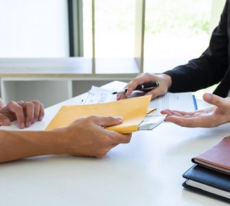 Person signing a contract and being given cash